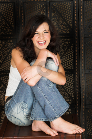 To use this stock image in your creative project, please select the size you need over to the right and click the "Add to Cart" button.
Your downloaded image will come with the Cutcaster watermark removed so don’t worry about the watermark you see on this page. Young brunette woman stock photo, Young adult brunette woman with a white top and long brown curly hair and brown eyes sitting on a leather suitcase with bare feet looking at the camera and smiling by Sean Nel