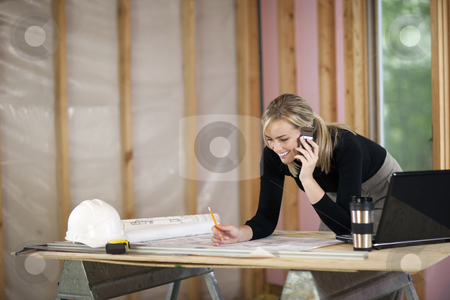 To use this stock image in your creative project, please select the size you need over to the right and click the "Add to Cart" button.
Your downloaded image will come with the Cutcaster watermark removed so don’t worry about the watermark you see on this page. Woman Working at Construction Site stock photo, A young woman is looking at blueprints and talking on the phone. She is working at a construction site. Horizontally framed shot. by Edward Bock