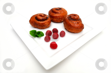 To use this stock image in your creative project, please select the size you need over to the right and click the "Add to Cart" button.
Your downloaded image will come with the Cutcaster watermark removed so don’t worry about the watermark you see on this page. Cinnamon Roll stock photo, Cinnamon buns and fresh red Raspberries on a square white plate isolated on white by Lynn Bendickson