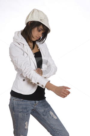 To use this stock image in your creative project, please select the size you need over to the right and click the "Add to Cart" button.
Your downloaded image will come with the Cutcaster watermark removed so don’t worry about the watermark you see on this page. Pulling sleeve up stock photo, Teenage girl pulling up her sleeve wearing knitted hat and jeans with holes by Yann Poirier