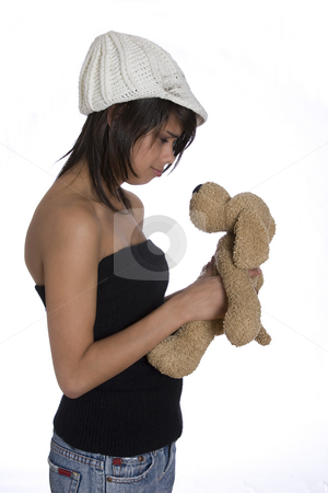 To use this stock image in your creative project, please select the size you need over to the right and click the "Add to Cart" button.
Your downloaded image will come with the Cutcaster watermark removed so don’t worry about the watermark you see on this page. Sad teen girl stock photo, Teenage girl wearing a black tube top, knitted hat and jeans with holes holding a brown stuff dog plush toy with sad expression by Yann Poirier