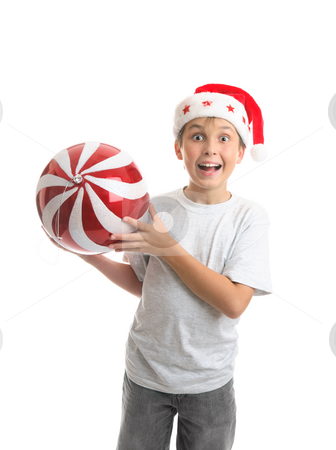 To use this stock image in your creative project, please select the size you need over to the right and click the "Add to Cart" button.
Your downloaded image will come with the Cutcaster watermark removed so don’t worry about the watermark you see on this page. Child boy holding Christmas bauble decoration stock photo, An excited ecstatic boy holding a big Christmas bauble ball decoration. Red and white with sparkling glitter and a silver thread by Leah-Anne Thompson