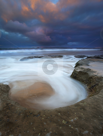 To use this stock image in your creative project, please select the size you need over to the right and click the "Add to Cart" button.
Your downloaded image will come with the Cutcaster watermark removed so don’t worry about the watermark you see on this page. Sunrise Spin Cycle stock photo, A natural bowl catches the rising tides in a spin cycle as dawn' s first light hits the passing storm clouds over Knight's Beach by Mike Dawson