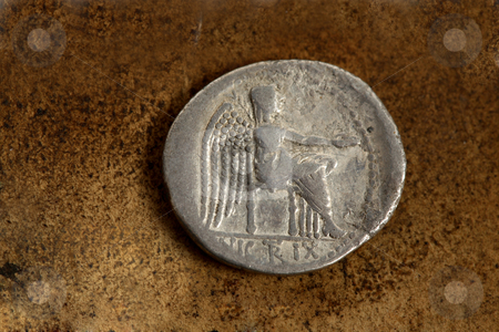 To use this stock image in your creative project, please select the size you need over to the right and click the "Add to Cart" button.
Your downloaded image will come with the Cutcaster watermark removed so don’t worry about the watermark you see on this page. Roman Silver Coin 89 BC stock photo, Reverse side of Roman Republic (200-30bc) silver coin AR denarius (89bc) depicting Victory Seated. The Victoire sitting. With the epigraph, VICTRIX. by Leah-Anne Thompson
