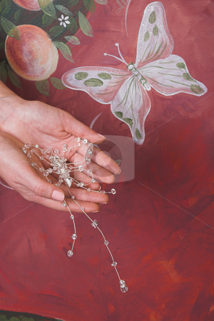 To use this stock image in your creative project, please select the size you need over to the right and click the "Add to Cart" button.
Your downloaded image will come with the Cutcaster watermark removed so don’t worry about the watermark you see on this page. Beaded Butterfly stock photo, Beaded butterfly in hands against a painted wall by Carla Booysen
