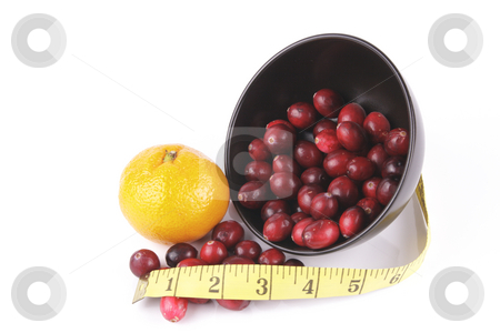 To use this stock image in your creative project, please select the size you need over to the right and click the "Add to Cart" button.
Your downloaded image will come with the Cutcaster watermark removed so don’t worry about the watermark you see on this page. Cranberries spilling out of a Black Bowl with Tape Measure stock photo, Red ripe cranberries spilling out of a small round black bowl on its side with a tape measure and satsuma on a reflective white background by Keith Wilson