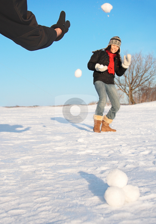 To use this stock image in your creative project, please select the size you need over to the right and click the "Add to Cart" button.
Your downloaded image will come with the Cutcaster watermark removed so don’t worry about the watermark you see on this page. Winter fun - snowball fight stock photo, Snowball fight - winter fun. Couple throwing snowballs at each other. by Maridav