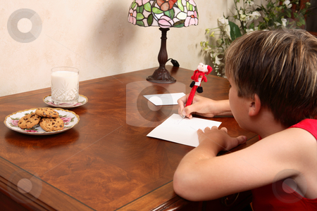 To use this stock image in your creative project, please select the size you need over to the right and click the "Add to Cart" button.
Your downloaded image will come with the Cutcaster watermark removed so don’t worry about the watermark you see on this page. Writing a Christmas letter or card stock photo, A child sitting at a desk writing a letter by Leah-Anne Thompson