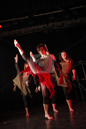 To use this stock image in your creative project, please select the size you need over to the right and click the "Add to Cart" button.
Your downloaded image will come with the Cutcaster watermark removed so don’t worry about the watermark you see on this page. Dancers on stage stock photo, A group of female freestyle hip-hop dancers in a dancing training session. Lit with spotlights. Movement on edges of dancers, kicking high. by Sean Nel