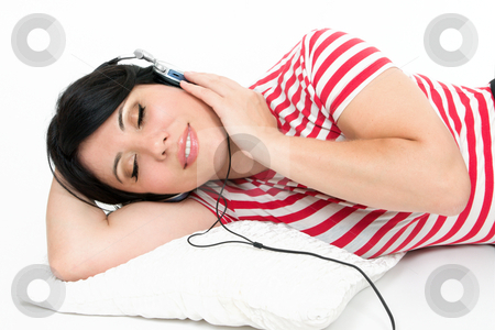 To use this stock image in your creative project, please select the size you need over to the right and click the "Add to Cart" button.
Your downloaded image will come with the Cutcaster watermark removed so don’t worry about the watermark you see on this page. Woman resting with favourite music stock photo, A woman at leisure relaxes to some music by Leah-Anne Thompson