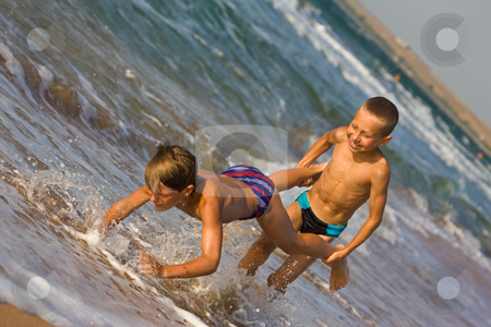To use this stock image in your creative project, please select the size you need over to the right and click the "Add to Cart" button.
Your downloaded image will come with the Cutcaster watermark removed so don’t worry about the watermark you see on this page. Two boy stock photo, People series: two boy are play the game on sea beach by Gennady Kravetsky