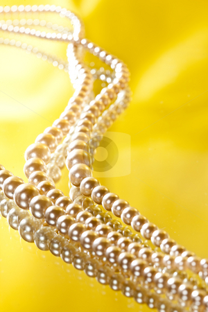 To use this stock image in your creative project, please select the size you need over to the right and click the "Add to Cart" button.
Your downloaded image will come with the Cutcaster watermark removed so don’t worry about the watermark you see on this page. Beads stock photo, Female decoration, simulated pearls over yellow background by Gennady Kravetsky