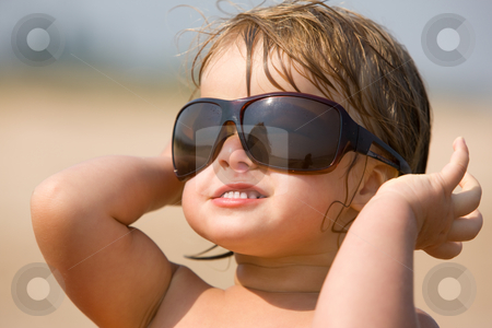 To use this stock image in your creative project, please select the size you need over to the right and click the "Add to Cart" button.
Your downloaded image will come with the Cutcaster watermark removed so don’t worry about the watermark you see on this page. Childhood stock photo, Little girl are play with the sun glasses by Gennady Kravetsky