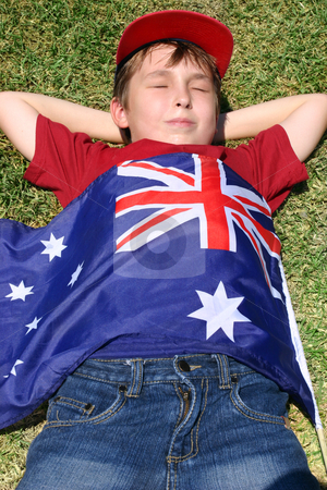 To use this stock image in your creative project, please select the size you need over to the right and click the "Add to Cart" button.
Your downloaded image will come with the Cutcaster watermark removed so don’t worry about the watermark you see on this page. Patriotic boy with flag draped over him stock photo, Patriotic boy with flag draped over him laying in park. by Leah-Anne Thompson