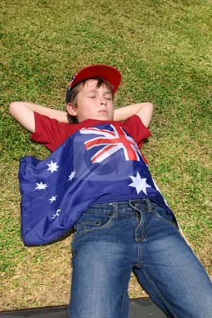To use this stock image in your creative project, please select the size you need over to the right and click the "Add to Cart" button.
Your downloaded image will come with the Cutcaster watermark removed so don’t worry about the watermark you see on this page. Patriotic boy stock photo, Patriotic Australian boy with Australian flag taking a short rest on grassy area. by Leah-Anne Thompson