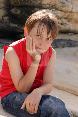 To use this stock image in your creative project, please select the size you need over to the right and click the "Add to Cart" button.
Your downloaded image will come with the Cutcaster watermark removed so don’t worry about the watermark you see on this page. Child sitting on rocks stock photo, A young child dressed in jeans and tank top sitting and thinking by rocks. by Leah-Anne Thompson