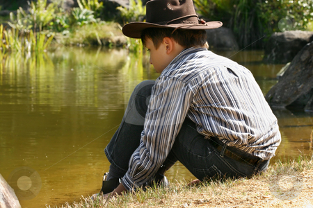 To use this stock image in your creative project, please select the size you need over to the right and click the "Add to Cart" button.
Your downloaded image will come with the Cutcaster watermark removed so don’t worry about the watermark you see on this page. Child sitting by outback billabong stock photo, A child wearing jeans, shirt and hat sits quietly by the edge of a pond by Leah-Anne Thompson
