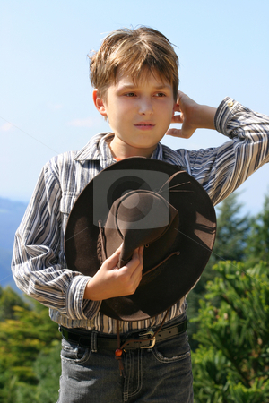 To use this stock image in your creative project, please select the size you need over to the right and click the "Add to Cart" button.
Your downloaded image will come with the Cutcaster watermark removed so don’t worry about the watermark you see on this page. Country farm boy stock photo, Outback rural boy in magnificent high country, holding hat, whilst rustling hair and looking out over the field on a sunny day. by Leah-Anne Thompson