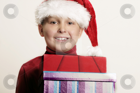 To use this stock image in your creative project, please select the size you need over to the right and click the "Add to Cart" button.
Your downloaded image will come with the Cutcaster watermark removed so don’t worry about the watermark you see on this page. Child bearing gifts stock photo, Child holding christmas gifts by Leah-Anne Thompson