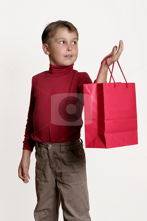 To use this stock image in your creative project, please select the size you need over to the right and click the "Add to Cart" button.
Your downloaded image will come with the Cutcaster watermark removed so don’t worry about the watermark you see on this page. Child with a red gift bag stock photo, Child holding a red gift bag in one hand and looking off to the side. by Leah-Anne Thompson