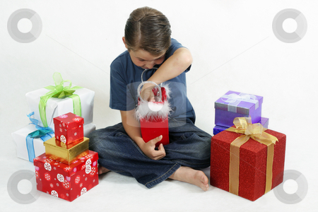 To use this stock image in your creative project, please select the size you need over to the right and click the "Add to Cart" button.
Your downloaded image will come with the Cutcaster watermark removed so don’t worry about the watermark you see on this page. Christmas Fun stock photo, Boy opening presents on Christmas day. Gifts scattered around him. by Leah-Anne Thompson