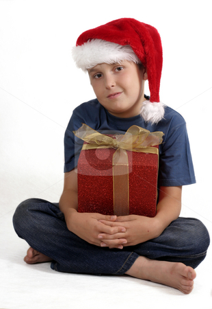 To use this stock image in your creative project, please select the size you need over to the right and click the "Add to Cart" button.
Your downloaded image will come with the Cutcaster watermark removed so don’t worry about the watermark you see on this page. Sitting boy with Christmas Gift stock photo, Sitting cross legged boy in blue jeans and t-shirt holding a red wrapped gift with a gold bow. by Leah-Anne Thompson