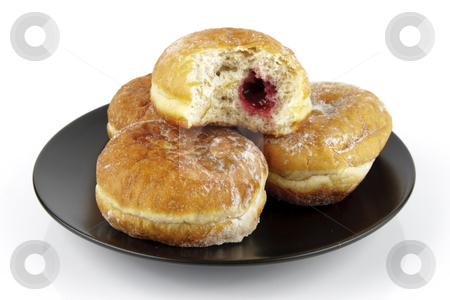 To use this stock image in your creative project, please select the size you need over to the right and click the "Add to Cart" button.
Your downloaded image will come with the Cutcaster watermark removed so don’t worry about the watermark you see on this page. Plate of Doughnuts with Bite Mark stock photo, Black round plate of jam doughnuts with a bite mark on one showing red jam on a reflective white background by Keith Wilson