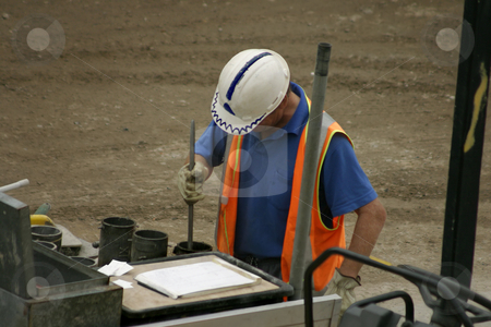 To use this stock image in your creative project, please select the size you need over to the right and click the "Add to Cart" button.
Your downloaded image will come with the Cutcaster watermark removed so don’t worry about the watermark you see on this page. Concrete moulds stock photo, A man stomps concrete into moulds on a construction site according to plans. Focus on head. Some movement by Leah-Anne Thompson