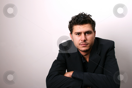To use this stock image in your creative project, please select the size you need over to the right and click the "Add to Cart" button.
Your downloaded image will come with the Cutcaster watermark removed so don’t worry about the watermark you see on this page. Male Model in Dark Lighting stock photo, Male model in studio against white wall by Vanessa Van Rensburg