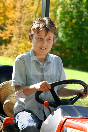 To use this stock image in your creative project, please select the size you need over to the right and click the "Add to Cart" button.
Your downloaded image will come with the Cutcaster watermark removed so don’t worry about the watermark you see on this page. Child on a small tractor stock photo, Child riding on a small tractor by Leah-Anne Thompson