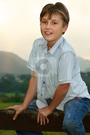 To use this stock image in your creative project, please select the size you need over to the right and click the "Add to Cart" button.
Your downloaded image will come with the Cutcaster watermark removed so don’t worry about the watermark you see on this page. Child sitting on fence stock photo, Child straddling a fence in the paddock at sunset dusk. by Leah-Anne Thompson