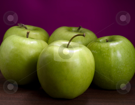 To use this stock image in your creative project, please select the size you need over to the right and click the "Add to Cart" button.
Your downloaded image will come with the Cutcaster watermark removed so don’t worry about the watermark you see on this page. Green ripe apples stock photo, Fresh green apples on the wooden table , closeup shot against purple background by Vladimir Koletic