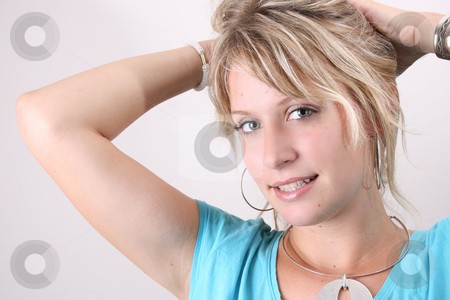 To use this stock image in your creative project, please select the size you need over to the right and click the "Add to Cart" button.
Your downloaded image will come with the Cutcaster watermark removed so don’t worry about the watermark you see on this page. Tying Hair stock photo, Blonde Female model taking up her hair to tie with a hair band by Vanessa Van Rensburg