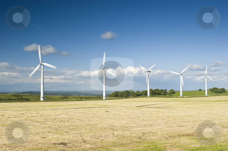 To use this stock image in your creative project, please select the size you need over to the right and click the "Add to Cart" button.
Your downloaded image will come with the Cutcaster watermark removed so don’t worry about the watermark you see on this page. Wind Farm Yorkshire stock photo, Power generation wind farm 35m in height to the hub and have a rotor diameter of 37m fossil fuel power stations in background by Stephen Meese