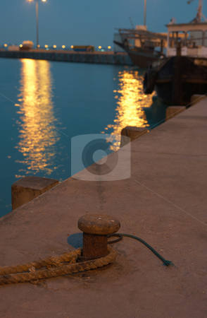 To use this stock image in your creative project, please select the size you need over to the right and click the "Add to Cart" button.
Your downloaded image will come with the Cutcaster watermark removed so don’t worry about the watermark you see on this page. Harbor at night stock photo, Mooring ring on the pier of the Al waker harbor just outside Doha in Qatar. Lights reflect on the water in the background. Colour cast from Pier Spotlights by Sean Nel