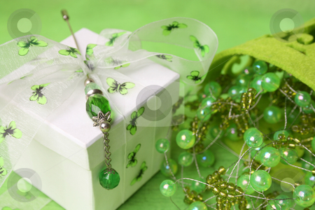 To use this stock image in your creative project, please select the size you need over to the right and click the "Add to Cart" button.
Your downloaded image will come with the Cutcaster watermark removed so don’t worry about the watermark you see on this page. Gift Box with Pin stock photo, White gift box with ribbon and beaded decorations by Vanessa Van Rensburg