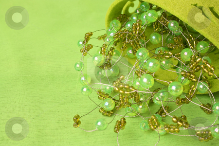 To use this stock image in your creative project, please select the size you need over to the right and click the "Add to Cart" button.
Your downloaded image will come with the Cutcaster watermark removed so don’t worry about the watermark you see on this page. Beadwork stock photo, Green beadwork on a green background in a filt cup by Vanessa Van Rensburg