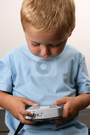 To use this stock image in your creative project, please select the size you need over to the right and click the "Add to Cart" button.
Your downloaded image will come with the Cutcaster watermark removed so don’t worry about the watermark you see on this page. Photographer stock photo, Shy toddler holding a silver camera, looking at his object by Vanessa Van Rensburg