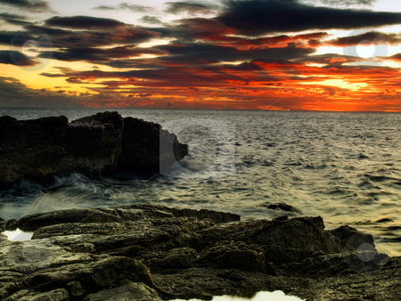 To use this stock image in your creative project, please select the size you need over to the right and click the "Add to Cart" button.
Your downloaded image will come with the Cutcaster watermark removed so don’t worry about the watermark you see on this page. Windy sunset stock photo, Dark coast, strong wind and red sunset over sea. by Sinisa Botas