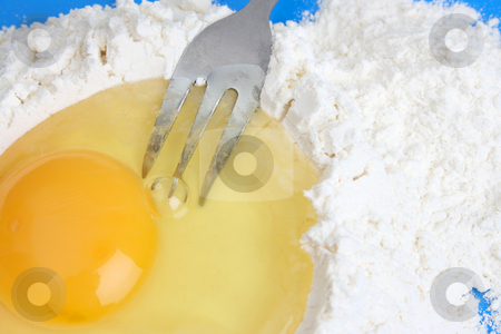 To use this stock image in your creative project, please select the size you need over to the right and click the "Add to Cart" button.
Your downloaded image will come with the Cutcaster watermark removed so don’t worry about the watermark you see on this page. Egg and Flour stock photo, Raw egg in flour with fork on blue background by Vanessa Van Rensburg
