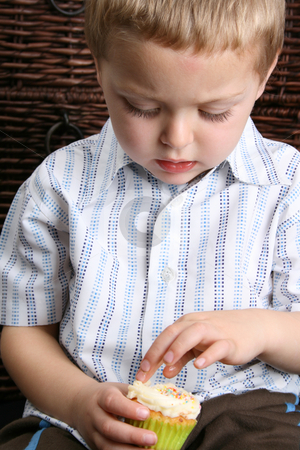 To use this stock image in your creative project, please select the size you need over to the right and click the "Add to Cart" button.
Your downloaded image will come with the Cutcaster watermark removed so don’t worry about the watermark you see on this page. Blond Boy stock photo, Beautiful blond boy busy eating a vanilla cupcake by Vanessa Van Rensburg