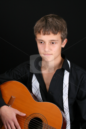 To use this stock image in your creative project, please select the size you need over to the right and click the "Add to Cart" button.
Your downloaded image will come with the Cutcaster watermark removed so don’t worry about the watermark you see on this page. Casual Teen stock photo, Teenage male in casual attire playing guitar by Vanessa Van Rensburg