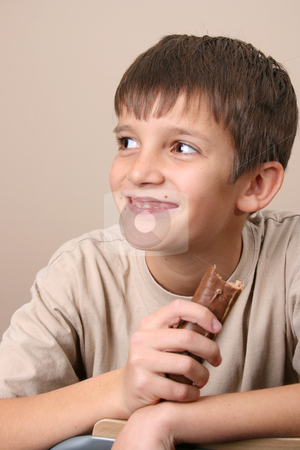 To use this stock image in your creative project, please select the size you need over to the right and click the "Add to Cart" button.
Your downloaded image will come with the Cutcaster watermark removed so don’t worry about the watermark you see on this page. Chocolate Kids stock photo, Young boy with big eyes, eating a chocolate bar by Vanessa Van Rensburg