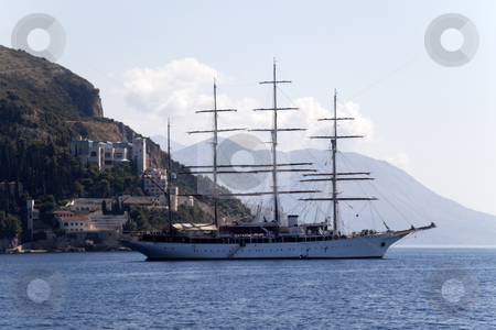 To use this stock image in your creative project, please select the size you need over to the right and click the "Add to Cart" button.
Your downloaded image will come with the Cutcaster watermark removed so don’t worry about the watermark you see on this page. Pirate Ship stock photo, A lone pirate ship out on the blue seas by Kevin Tietz