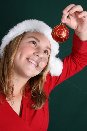 To use this stock image in your creative project, please select the size you need over to the right and click the "Add to Cart" button.
Your downloaded image will come with the Cutcaster watermark removed so don’t worry about the watermark you see on this page. Christmas Girl stock photo, Beautiful teenager wearing a red shirt and christmas hat by Vanessa Van Rensburg