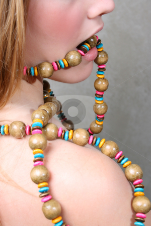 To use this stock image in your creative project, please select the size you need over to the right and click the "Add to Cart" button.
Your downloaded image will come with the Cutcaster watermark removed so don’t worry about the watermark you see on this page. Female Model stock photo, Beautiful female model a string beads in her mouth by Vanessa Van Rensburg