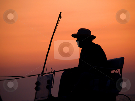 To use this stock image in your creative project, please select the size you need over to the right and click the "Add to Cart" button.
Your downloaded image will come with the Cutcaster watermark removed so don’t worry about the watermark you see on this page. Cowboy stock photo, Cowboy in coachman by Portokalis
