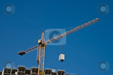 To use this stock image in your creative project, please select the size you need over to the right and click the "Add to Cart" button.
Your downloaded image will come with the Cutcaster watermark removed so don’t worry about the watermark you see on this page. Construction site stock photo, City series: building under construction with crane by Gennady Kravetsky