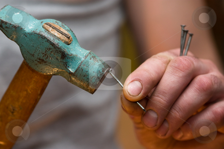 To use this stock image in your creative project, please select the size you need over to the right and click the "Add to Cart" button.
Your downloaded image will come with the Cutcaster watermark removed so don’t worry about the watermark you see on this page. Hammer in a nail
stock photo, Man hammering a nail, repair or construction by Gennady Kravetsky
