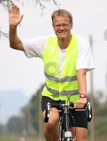 To use this stock image in your creative project, please select the size you need over to the right and click the "Add to Cart" button.
Your downloaded image will come with the Cutcaster watermark removed so don’t worry about the watermark you see on this page. Biker stock photo, A young man is waving from the bike cheerfully by ARPAD RADOCZY